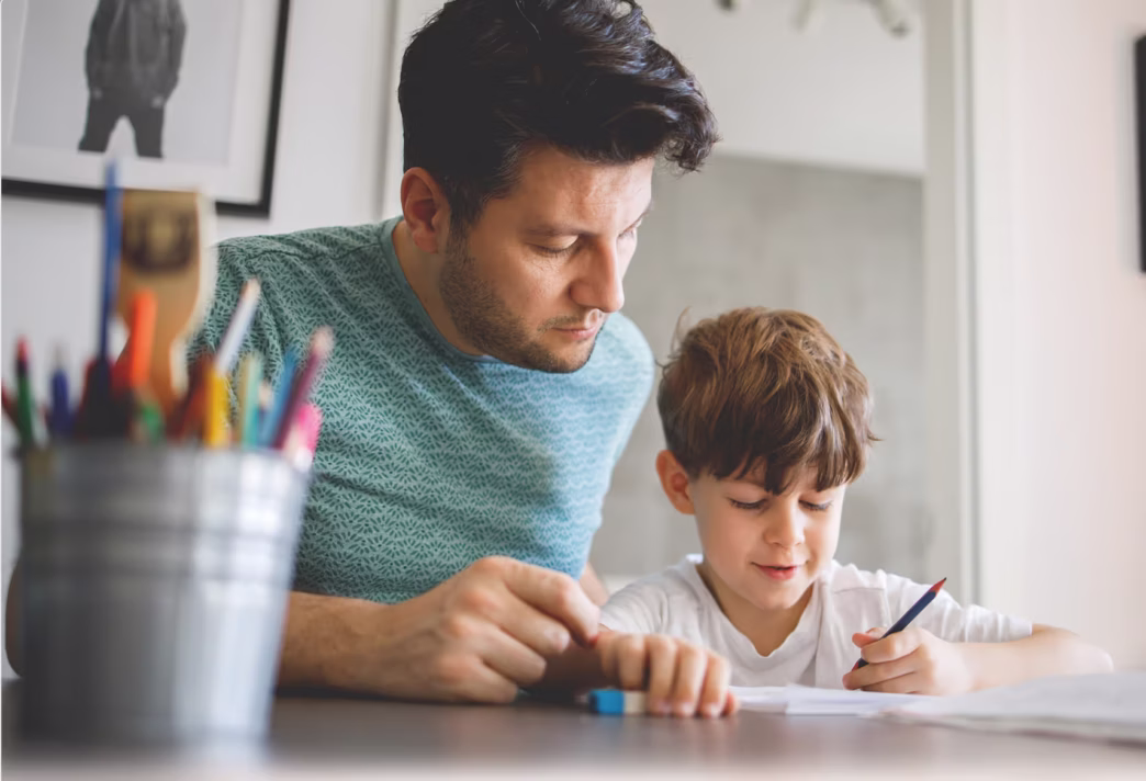 Dad helping son do his homework