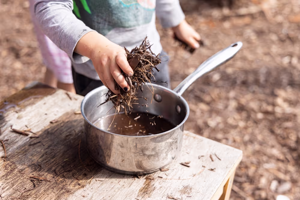 Child playing with a mud kitchen