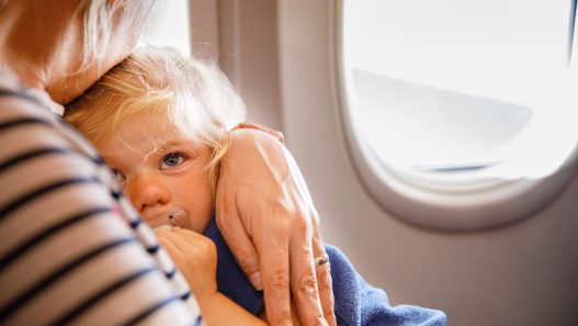 Helping child sleep on a plane